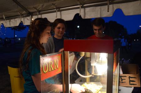 Students make popcorn for students and their families during Union Night on the Great Lawn.  - Photo by Anne Richoux
