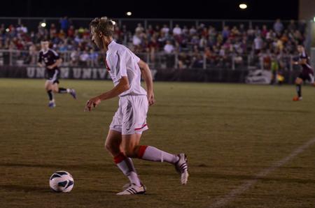 Bulldog Seth Guiler dribbles the ball downfield during a soccer game against Christian Brothers University. - Photo by Anne Richoux