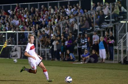 Bulldog Alex Pratt dribbles the ball past a Christian Brothers University player during a soccer game with great fan attendance.  - Photo by Anne Richoux