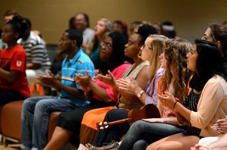 Students clap along as a band performs at the MOSAIC Unity Showcase.  - Photo by Anne Richoux