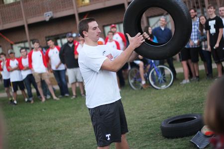 Jeff Williams, freshman, prepares to throw the tire as far as he can in the tire throw competition during the DF Olympics in the Heritage Complex. - Photo by Matt McDaniel