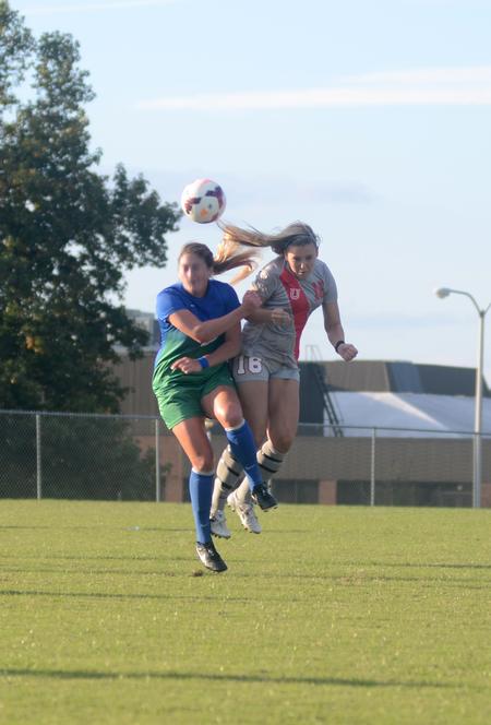 Lady Bulldog Hannah Miller, sophomore athletic training major, goes up against a University of West Florida opponent for possession of the ball. - Photo by Amanda Rohde