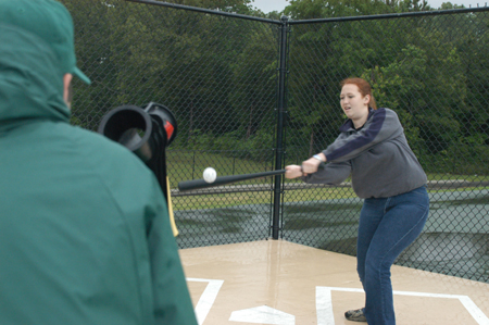 Mark VanderHaar pitches to senior Rachel Jones  during the whiffle ball challenge at Pringles Park during the Watters Amazing Race.  - Photo by Kristen Hiller