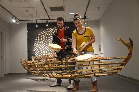 The work of Rod Crossman, currently featured in the Union art gallery, invites viewers to participate in the pieces. Zac Pankey and Sarah Lawler, sophomore art majors, make music with the various instruments built into the Time Capsule pieces. - Photo by Amanda Rohde