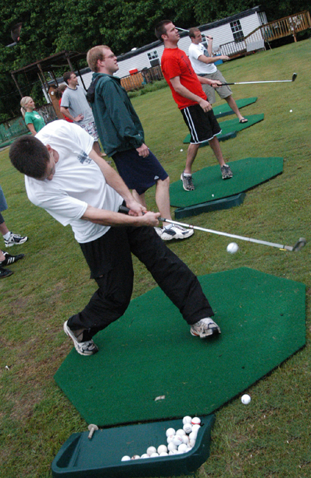 Senior Steve Yzaguirre attempts to hit a bullseye at the Dory Brothers driving range during the Watters Amazing Race. - Photo by Jonathan Blair