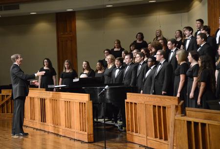 David Dennis, professor of music, directs the Women's and Men's Choir at the Fall Choral Concert held at First Baptist Church. - Photo by Amanda Rohde