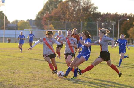 Lady Bulldogs Sara Johnson, Megan Roney, and Alex Taylor attack the ball to regain possession during their last home game at the Smith Memorial Soccer Complex.  - Photo by Anne Richoux