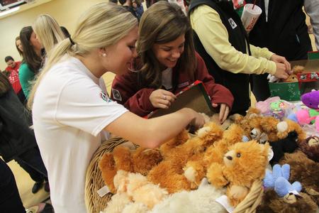 Allie Malone, sophomore nursing major, and Rachel West, junior family studies major, participate in Campus and Community: A Day of Remembrance and Service by putting together shoeboxes for Operation Christmas Child. - Photo by Matt McDaniel