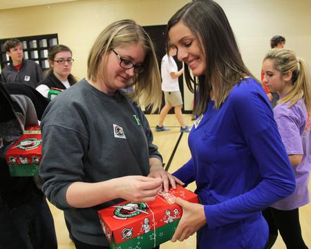 Brittany Banks, senior athletic training major, and Weatherly Russell, sophomore elementary education major, finish packing their box for Operation Christmas Child during Campus and Community: A Day of Remembrance and Service.  - Photo by Matt McDaniel