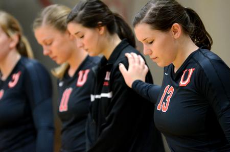Lady Bulldog Lydia Wright bows her head in prayer at the beginning of a volleyball game against University of West Florida at the Fred DeLay Gymnasium.  - Photo by Anne Richoux