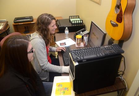 McKinley Tribble, sophomore elementary education major, and Kelly Robey, junior sports management major, create a lyric song book for clients of the STAR Center in Jackson during Campus and Community: A Day of Remembrance and Service.  - Photo by Jacob Moore
