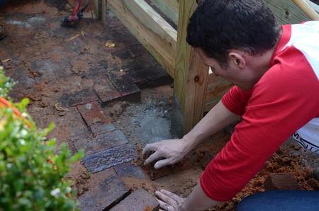 Jon Abernathy, director of the office of disability services, works with a team of students to build an accessibility ramp onto a house in Jackson as a part of the 11th annual Campus and Community: A Day of Remembrance and Service.  - Photo by Anne Richoux