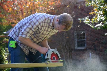 Sophomore Paul Day works with the Jackson Center for Independent Living to build an accessibility ramp during the 11th annual Campus and Community: A Day of Remembrance and Service.  - Photo by Anne Richoux