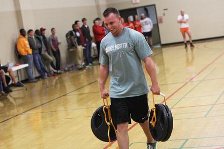 Photo by Matt McDaniel

Benjamin Fesmire, senior business administration major, carries the heavy weights during the farmer's walk portion during the annual Union's Most Fit competition in the small gym. - Photo by Matt McDaniel