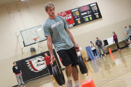 Caleb Pitman, freshman athletic training major, carries the heavy weights during the farmer's walk portion of the annual Union's Most Fit competition in the small gym. - Photo by Matt McDaniel
