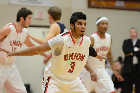 Bulldog Roy Bullock plays defense against Champion Baptist College in the Fred DeLay Gymnasium. The Bulldogs won 96-54.  - Photo by Anne Richoux