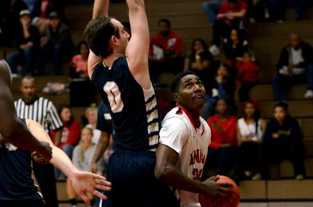 Bulldog Ashanti Day looks up before making a shot during a game against Champion Baptist College in the Fred DeLay Gymnasium. The Bulldogs won 96-54.  - Photo by Anne Richoux