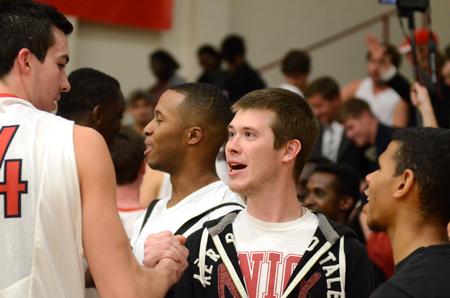 Bobby Bunn, sophomore sports medicine major, congratulates Bulldog Miguel Martinez after the Bulldogs' 96-54 win over Champion Baptist College. - Photo by Anne Richoux