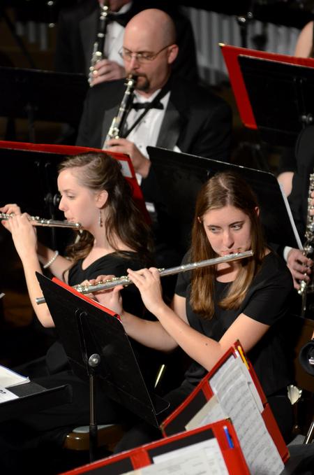 Rebekah Reisner (bottom right), freshman special education major, plays flute during the symphonic band concert at First Baptist Church.  - Photo by Anne Richoux