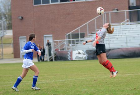 Lady Bulldog Rachel Boswell, senior athletic training major, heads the ball to keep it away from her Bluefield College opponent. - Photo by Amanda Rohde