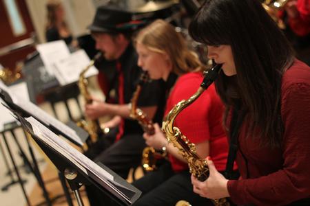 Abby Williams, sophomore, plays saxophone with the rest of the jazz band during their concert in Hartley Recital Hall.  - Photo by Matt McDaniel