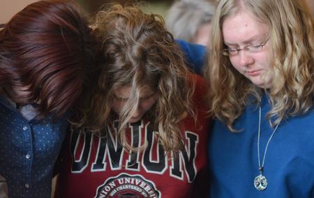 Students and faculty join together to pray in groups for students who are struggling with difficult decisions during chapel. - Photo by Amanda Rohde