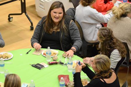 Kate Lawrence, senior business administration major, talks with her Zeta Tau Alpha sorority sisters during A Panhellenic Christmas in the Bowld Student Commons.  - Photo by Anne Richoux