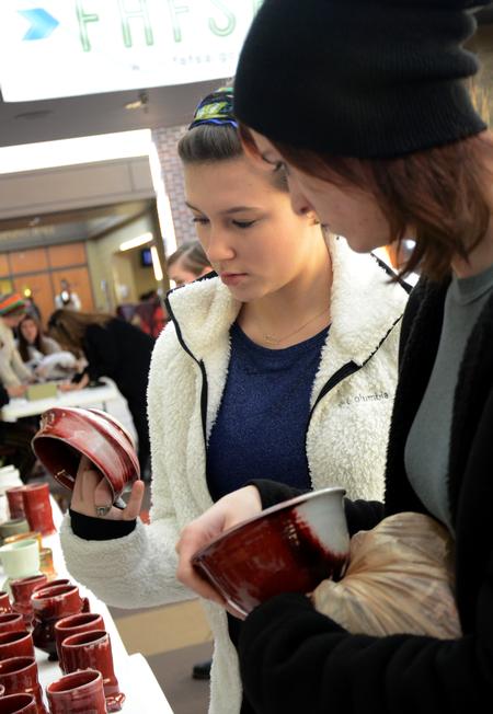 The Annual Christmas Pottery Sale is a great opportunity for students to purchase handmade Christmas gifts for friends and family. Sarah Lawler and Skylar Gregory, sophomore art majors, look at pottery made by Lee Benson, professor of art and department chair. - Photo by Amanda Rohde