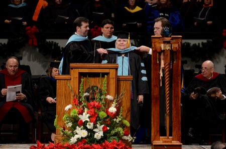 Janice Baldwin, doctor of education graduate, receives her doctoral hood during Fall Commencement Services.  - Photo by Anne Richoux