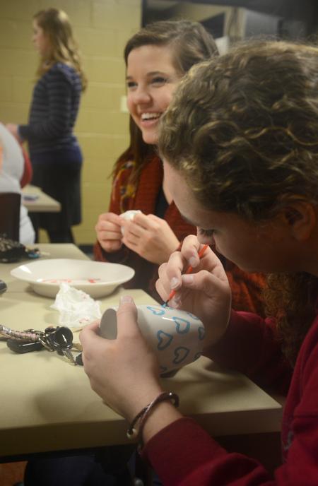 Students enjoy decorating mugs to support World Vision International at Residence Life's Mugs & Kisses event in the Bowld Student Commons. - Photo by MiKalla Cotton