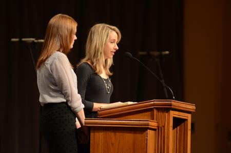 Hope Lewis, junior elementary education major, and Tori Brooks, senior english major read scripture during the prayer chapel in remembrance of Olivia Greenlee. - Photo by Matt McDaniel