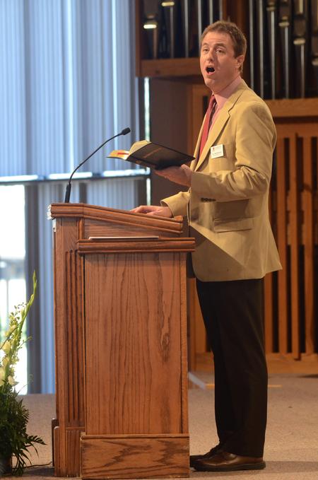 Chris Mathews, associate professor of music and department chair, leads in singing a hymn in chapel. - Photo by Amanda Rohde
