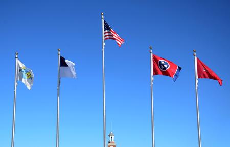 Flags donated by the 1963 Graduating Class are raised for the first time at the campus entrance during Homecoming. - Photo by Amanda Rohde