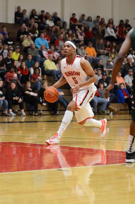 Bulldog AJ Roberts drives down the court during the homecoming game against Delta State in the Fred DeLay Gymnasium.  - Photo by Anne Richoux