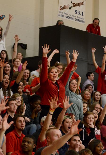 Students get excited as free merchandise is thrown into the crowd during the homecoming game. - Photo by Anne Richoux