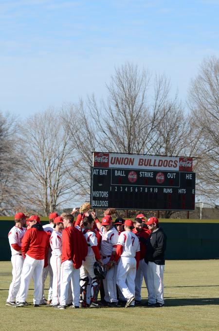 The Bulldogs huddle at the beginning of a game against Southern Arkansas University at Fesmire Field.  - Photo by Anne Richoux
