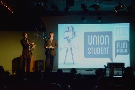 James Watlington, junior media communications major, pops confetti while Sam Jones, freshman digital media studies major, reads the winners of the Union Student Film Festival in Barefoots Joe. - Photo by Amanda Rohde