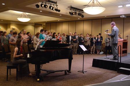Chris Mathews, associate professor of music and department chair, leads singing at PsalmFest II in the Carl Grant Events Center. - Photo by Amanda Rohde