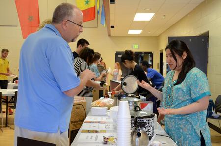A student explains her cultural treat with a visitor at the International Food Fair in the Bowld Student Commons. - Photo by MiKalla Cotton