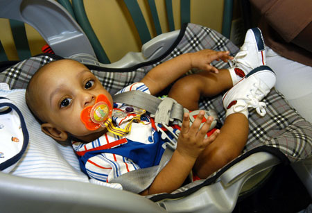 Four month old David Webster prepares for a special graduation day with his graduate mother LaToya. - Photo by Morris Abernathy