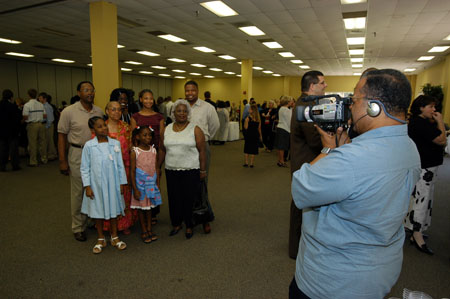 M.A.Ed. graduate Carol Lynn Reaves gathers with her family for photos at the summer graduation reception. - Photo by Morris Abernathy