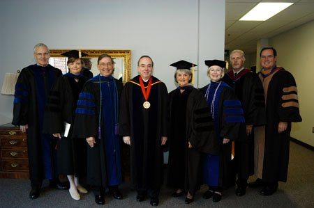 James Patterson, Carla Sanderson, Tom Rosebrough, David S. Dockery, Judy Fletcher, Donna Sachse, Kelvin Moore, and Keith Absher pose in their regalia shortly before summer graduation. - Photo by Morris Abernathy