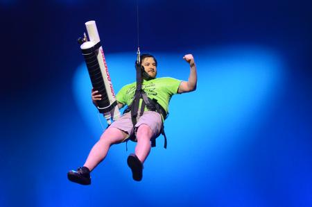 Sean Montes, owner of Burrito Meal, descends from the ceiling shooting Burrito Meal t-shirts from a t-shirt cannon for attendees of the 17th annual Variety Show. - Photo by Matt McDaniel