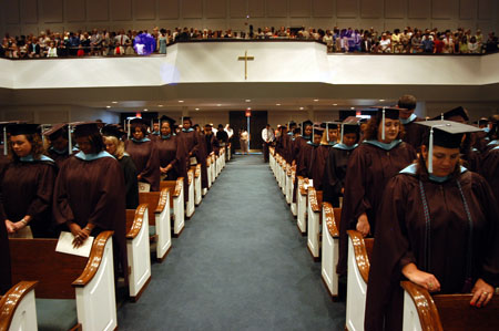 Graduates bow in prayer during the Aug. 7 service at West Jackson Baptist Church.
 - Photo by Morris Abernathy