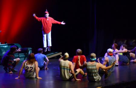 Joey Davis, senior business administration major, descends from the ceiling in Lambda Chi Alpha's performance for the 17th Annual Variety Show, hosted by SAC. - Photo by MiKalla Cotton