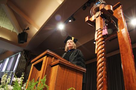Carla Sanderson, executive vice president for strategic initiatives and provost, reads through the award winners during Awards Day Chapel. - Photo by Matt McDaniel