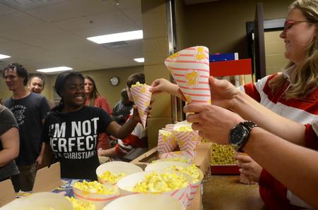 SAC members pass out popcorn to students during Movie in the Bowld.  - Photo by Anne Richoux