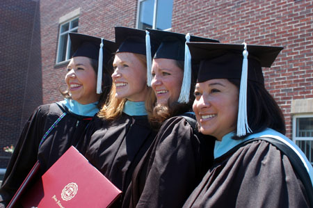 Melissa Farmer(second from the left) gets her photo taken with a few of her fellow master of education classmates. - Photo by Morris Abernathy