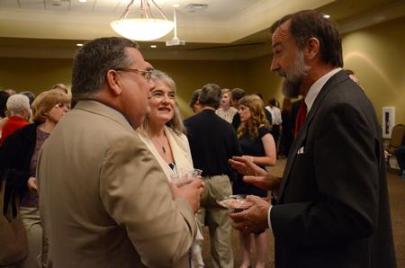 Hal Poe, special assistant to the president and faculty member of the year, converses with parents at the reception preceding graduation ceremonies. - Photo by MiKalla Cotton