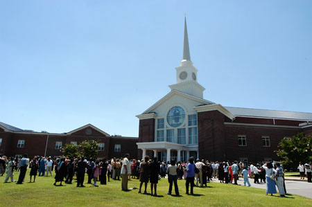 The happy graduates gather with family and friends after summer graduation on the front lawn of West Jackson Baptist Church. - Photo by Morris Abernathy